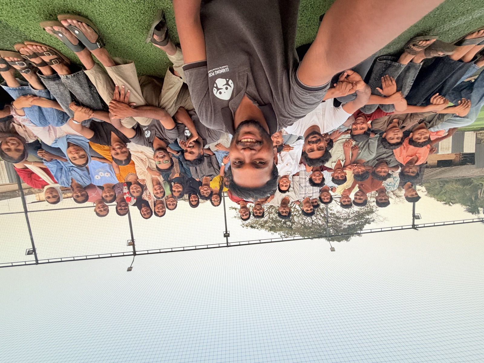 The whole Learning Pod team — a joyful group selfie on the turf